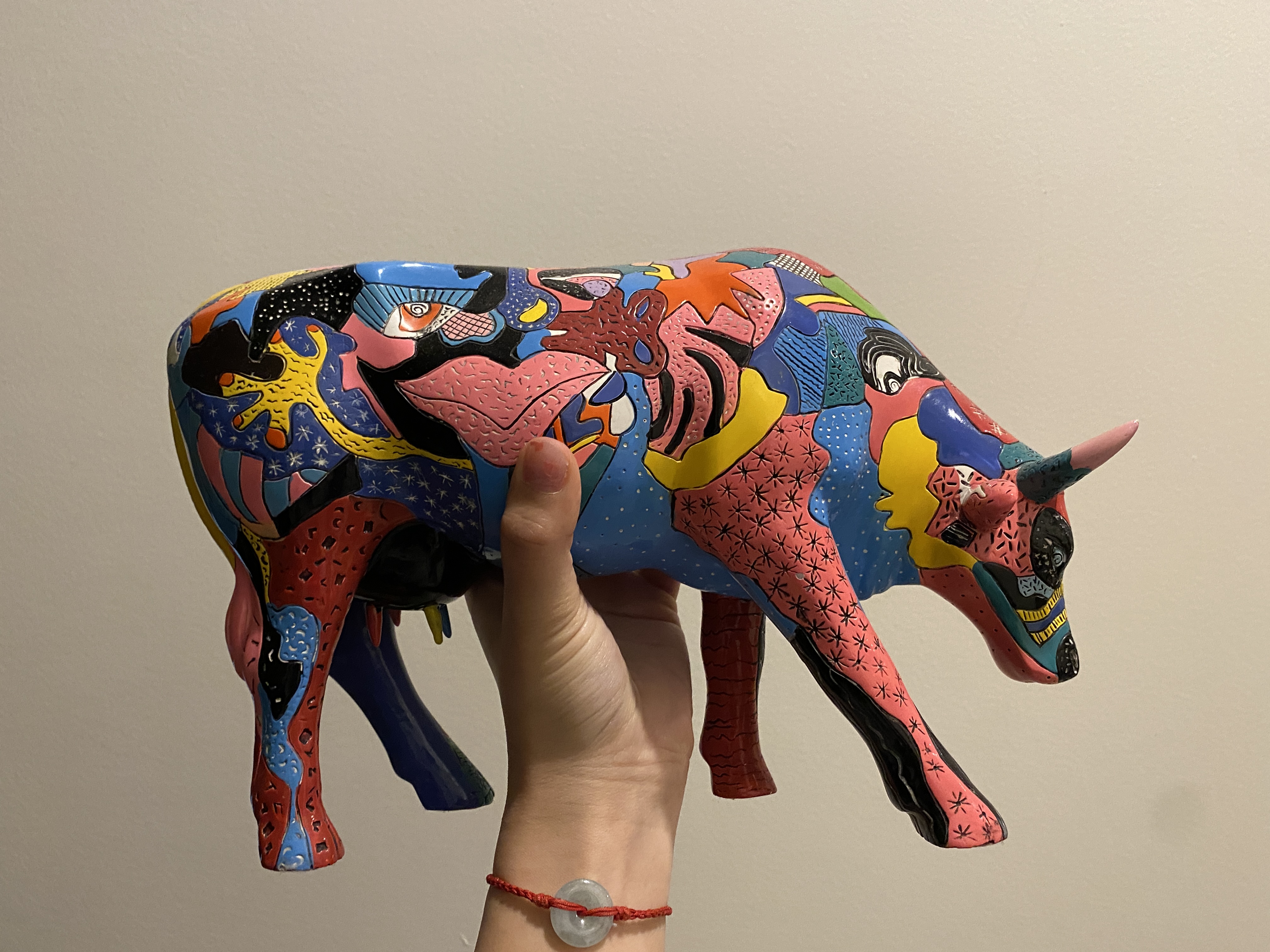 the left side of a funky cow. we have a better view of the rainbow blobs that covers her.